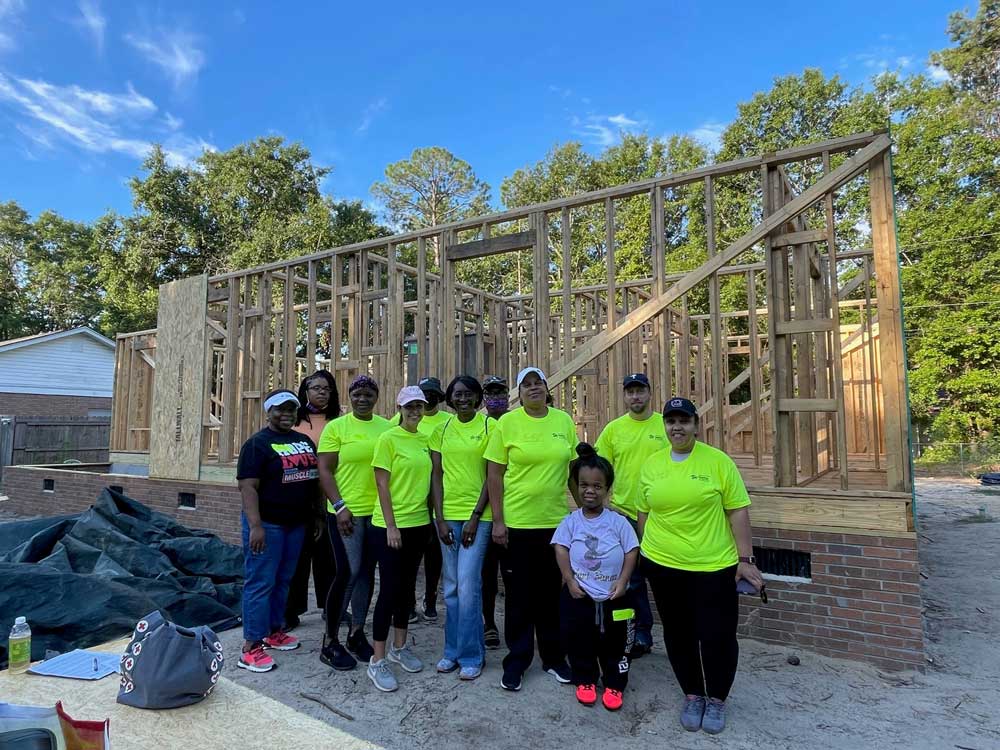 group of people in front of home build