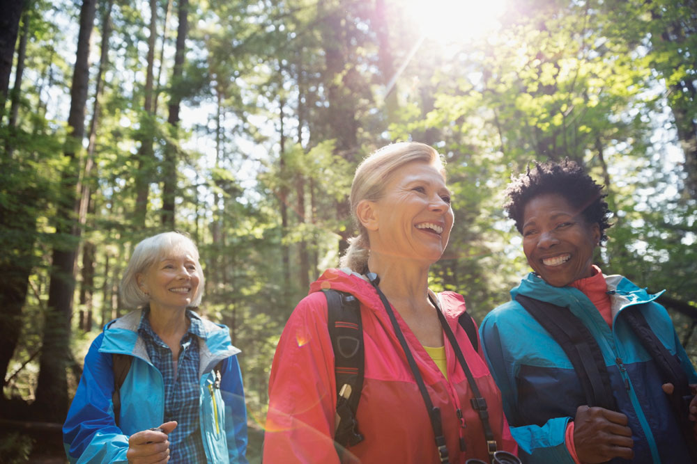 group of older women hiking in woods