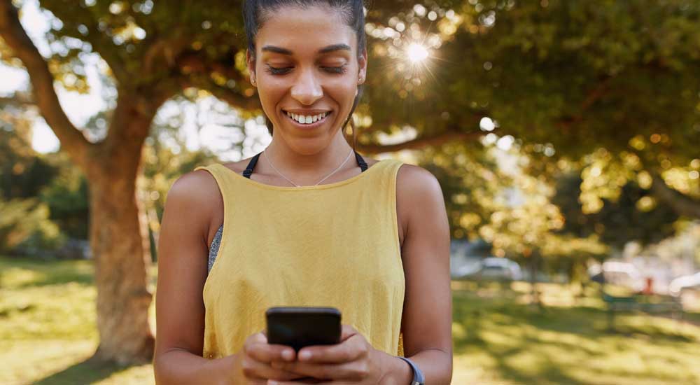 Woman outside holding phone